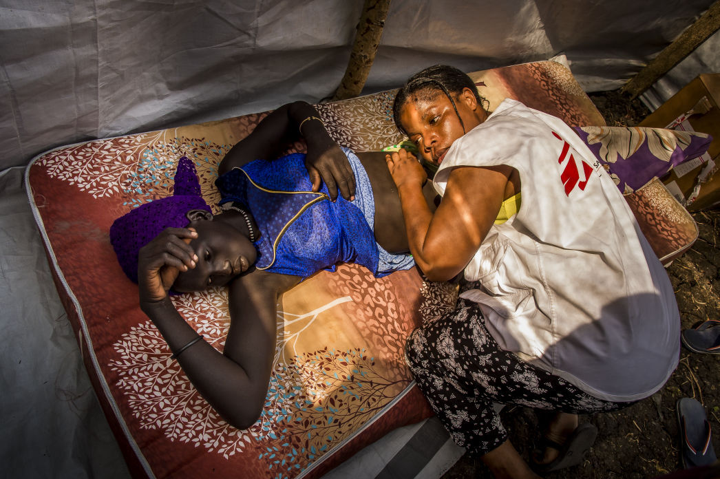 Nurse and midwife Furaha Bazikanya examines a young pregnant woman in one of the two consultation spaces at a mobile clinic in the village of Kier, South Sudan. Photo by Frederic Noy/COSMOS.