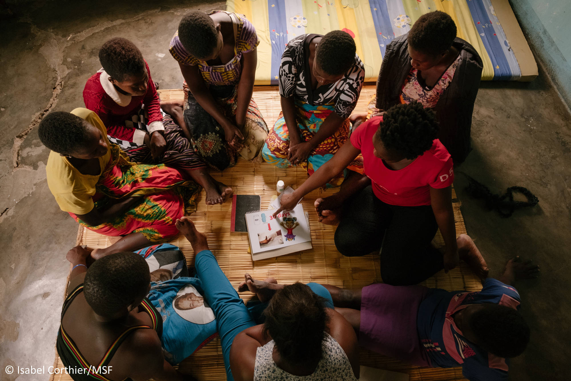 An MSF community health worker Adeline (not her real name) conducts a health promotion session with a sex worker community ART group in Nsanje. She uses interactive flip charts designed by sex workers or other teaching methods to promote knowledge of safer sex, HIV and STI prevention, sexual and gender based violence, hygiene, family planning & contraception and cervical cancer. She is trained to answer questions sex workers might have on their HIV treatment, or advice on challenges they face. Photo by Isabel Corthier/MSF.